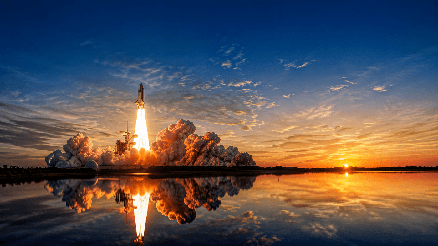 A space shuttle launching at dawn from a Florida launchpad, reflected in still water below